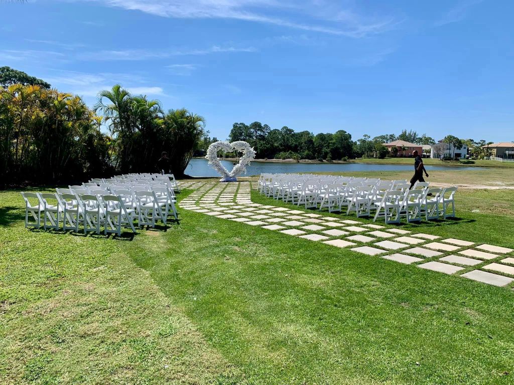 West Palm Beach Wedding Venue, waterfront wedding venue, Southern Florida wedding venue, West Palm Beach wedding ceremony, West Palm Beach outdoor wedding ceremony, wedding chairs, sunshine, country club wedding, palm trees, green landscaping, luxury country club wedding, affordable country club wedding, wedding ballroom, wedding banquet, Florida wedding venue