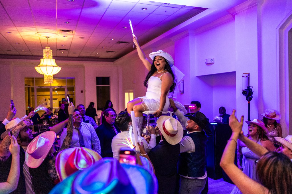 Ultimate Guide To Being In The Wedding Party, bride, wedding party, bridesmaids celebrating at the wedding reception venue in Palm Beach Florida