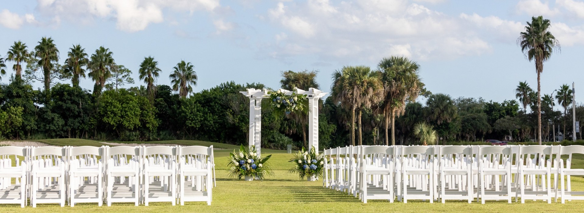 Palm Beach Florida wedding venue outdoor ceremony with luxury chairs and arch